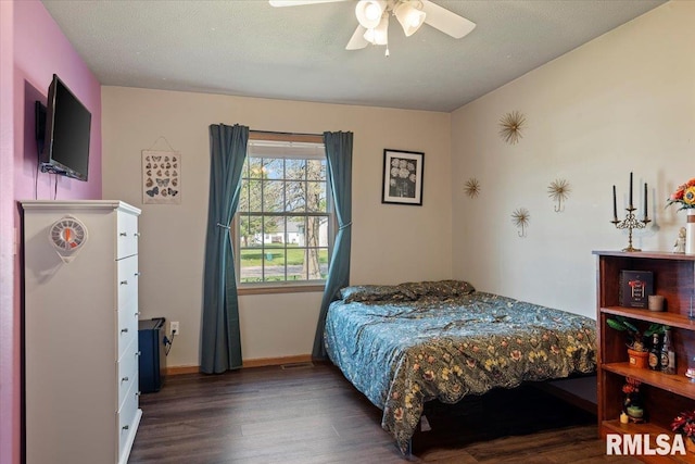 bedroom with baseboards, ceiling fan, and wood finished floors