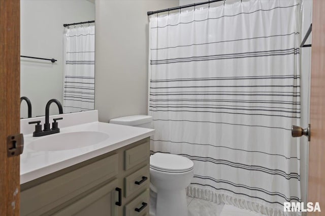 bathroom featuring toilet, curtained shower, and vanity