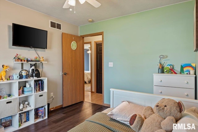 bedroom with baseboards, ceiling fan, wood finished floors, and visible vents