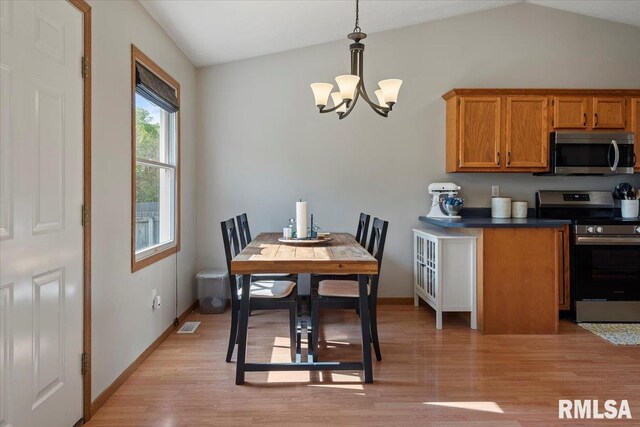 kitchen featuring brown cabinetry, light wood-type flooring, an inviting chandelier, and stainless steel appliances