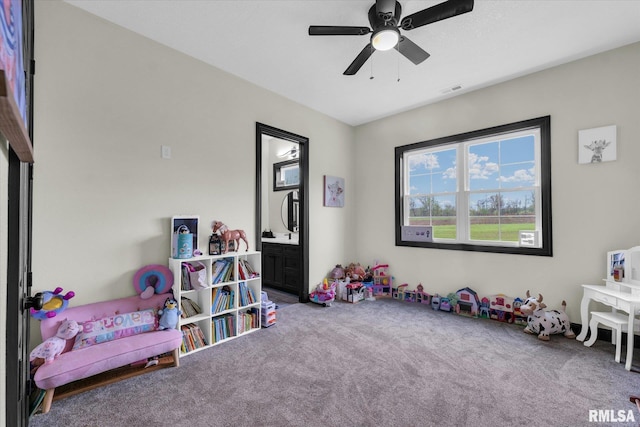 playroom with carpet, visible vents, and ceiling fan