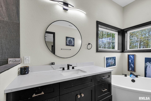 full bathroom with a freestanding tub and vanity