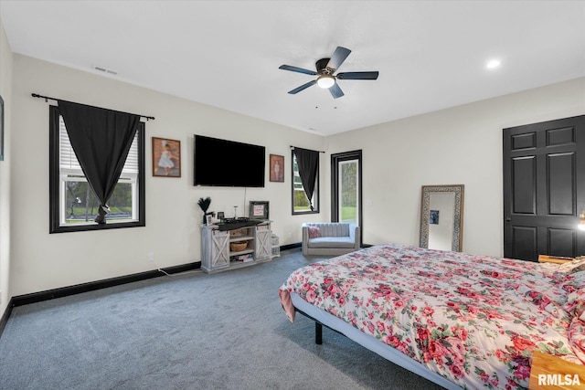 carpeted bedroom featuring baseboards, visible vents, and ceiling fan
