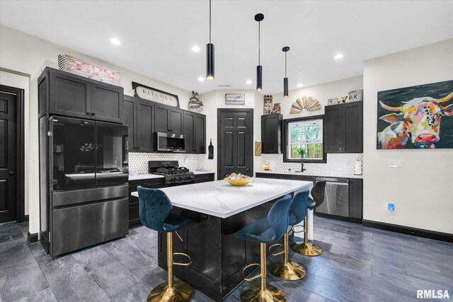 kitchen featuring light stone counters, tasteful backsplash, a breakfast bar, and stainless steel appliances