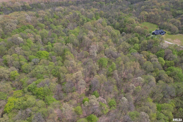 birds eye view of property with a wooded view