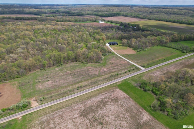 birds eye view of property with a wooded view and a rural view
