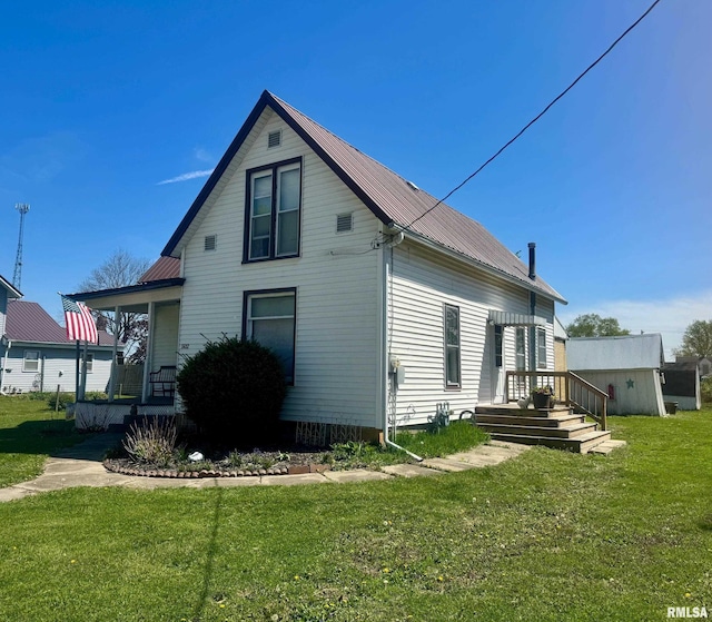 502 E Main St, Plymouth, IL 62367 - view of side of property with metal roof, a yard, and a porch