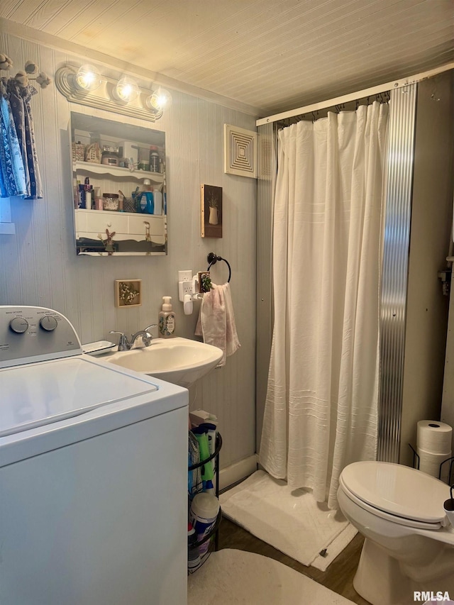 502 E Main St, Plymouth, IL 62367 - bathroom featuring washer / clothes dryer, toilet, a shower with shower curtain, and a sink