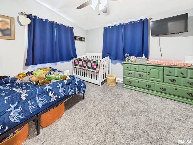 bedroom featuring a ceiling fan, vaulted ceiling, and carpet floors