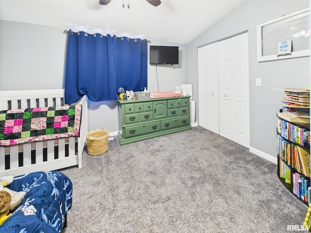 carpeted bedroom with a closet, ceiling fan, vaulted ceiling, and baseboards