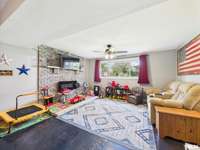 playroom with a brick fireplace and a ceiling fan