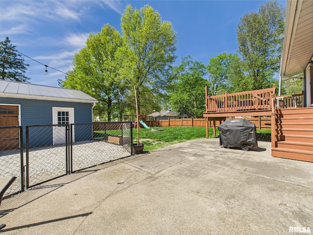 view of patio / terrace with a wooden deck, a playground, and fence