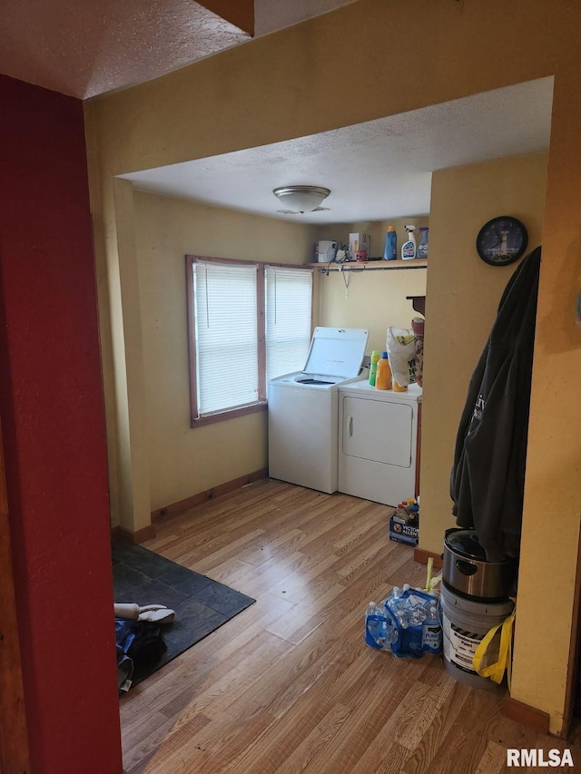 203 N 5th St, Oquawka, IL 61469 - laundry room with washer and clothes dryer, wood finished floors, and a textured ceiling