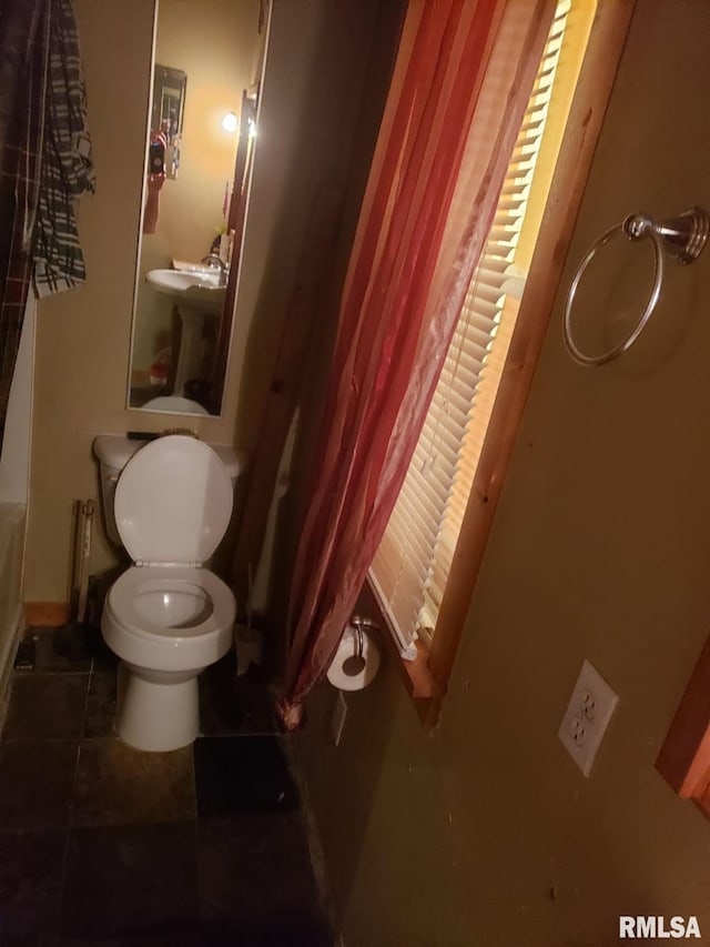 203 N 5th St, Oquawka, IL 61469 - bathroom featuring toilet, tile patterned flooring, and baseboards