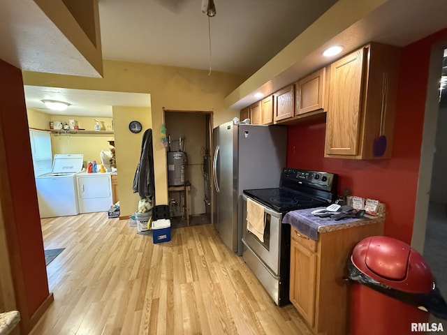 203 N 5th St, Oquawka, IL 61469 - kitchen featuring range with electric cooktop, washer and clothes dryer, light wood-type flooring, dark countertops, and electric water heater
