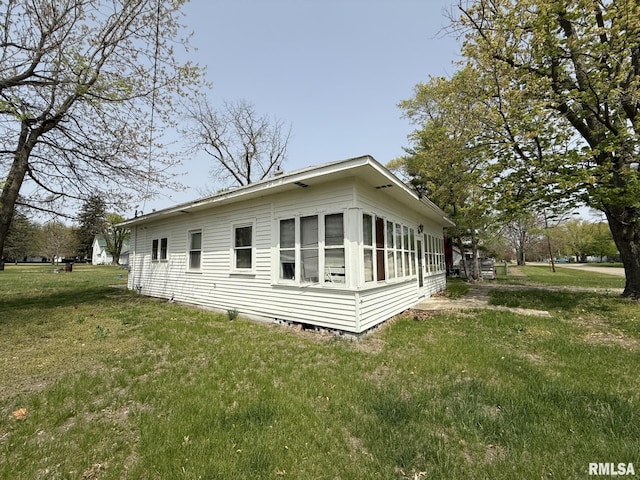 203 N 5th St, Oquawka, IL 61469 - view of home's exterior with a lawn and crawl space