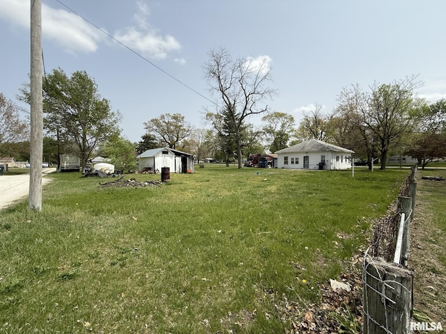 203 N 5th St, Oquawka, IL 61469 - view of green lawn featuring an outbuilding