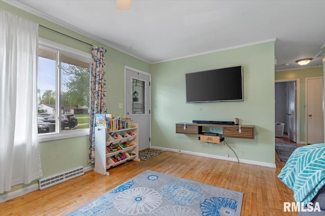 interior space featuring baseboards, visible vents, wood finished floors, and crown molding