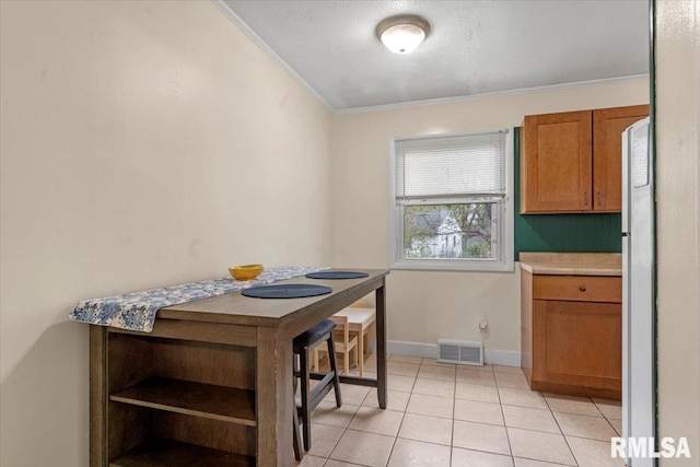 dining room with ornamental molding, light tile patterned flooring, visible vents, and baseboards