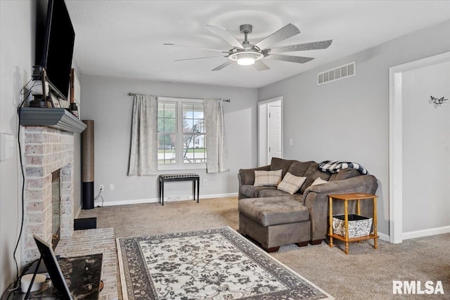 living area featuring a ceiling fan, visible vents, carpet floors, and baseboards