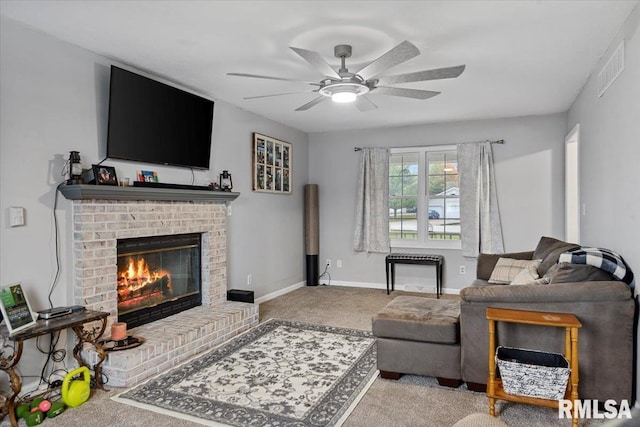 living area featuring ceiling fan, carpet flooring, a brick fireplace, baseboards, and visible vents
