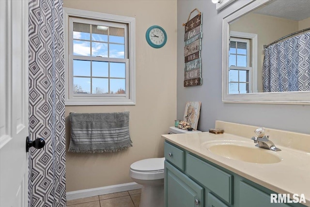 full bath with baseboards, toilet, tile patterned flooring, and vanity