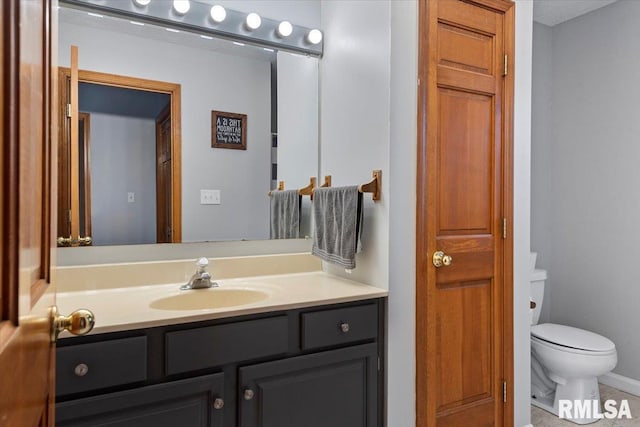 bathroom featuring toilet and vanity