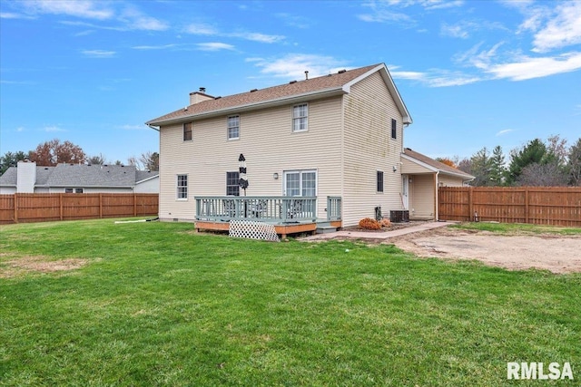 back of house with a deck, a chimney, a lawn, central AC, and a fenced backyard