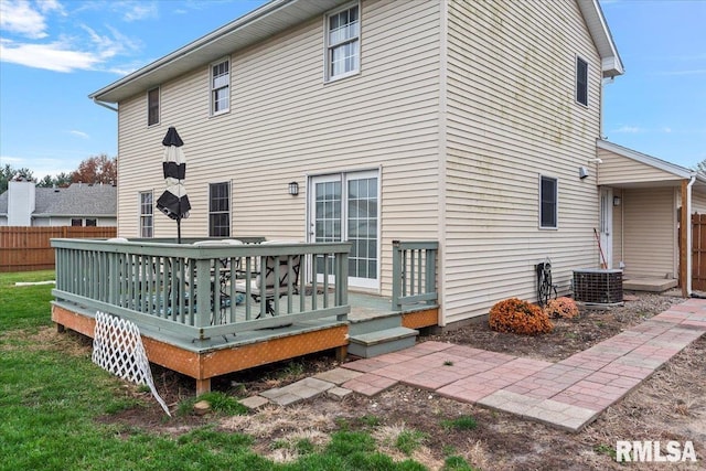 back of house featuring cooling unit, a deck, and fence