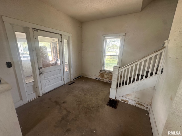 705 Olive St, Galesburg, IL 61401 - foyer entrance with a textured ceiling and unfinished concrete flooring