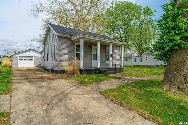 view of front of property with a garage, a porch, an outdoor structure, and concrete driveway
