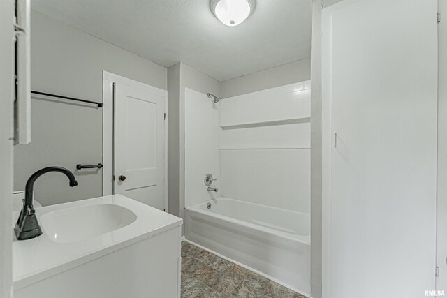 full bathroom with washtub / shower combination and a sink