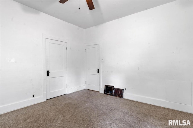 carpeted spare room with baseboards and ceiling fan