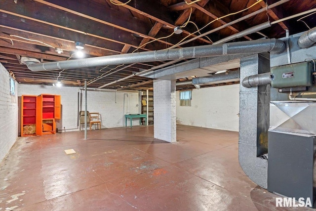 unfinished below grade area featuring heating unit