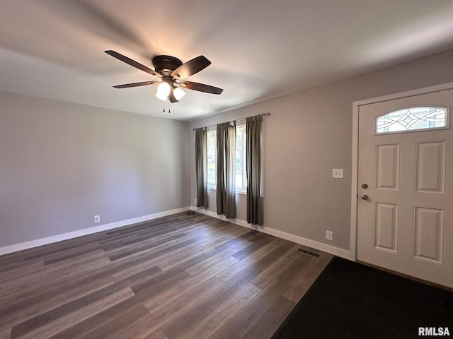 entrance foyer featuring ceiling fan, visible vents, baseboards, and dark wood-type flooring