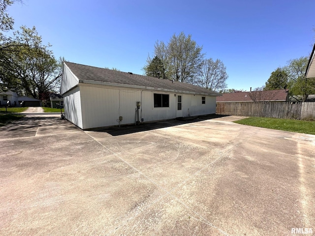 rear view of property with fence and a patio