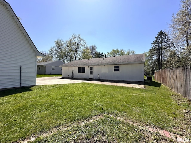 back of property featuring a yard, a patio, and fence