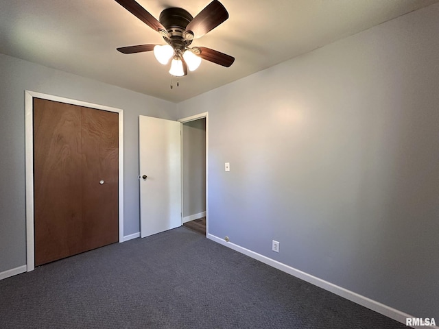 unfurnished bedroom with baseboards, ceiling fan, and dark carpet