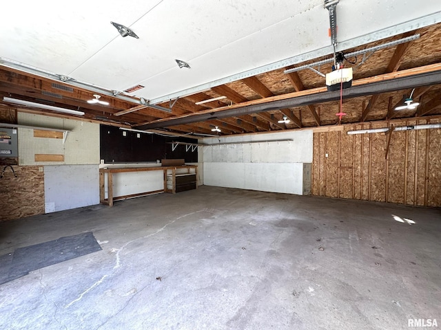 garage featuring a garage door opener and a workshop area