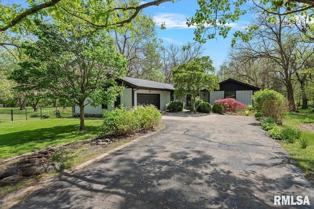 454 Brian Ln, Dawson, IL 62520 - mid-century modern home with fence, driveway, a front yard, and a garage