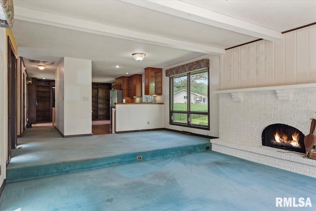 454 Brian Ln, Dawson, IL 62520 - unfurnished living room with carpet floors, beamed ceiling, baseboards, and a brick fireplace