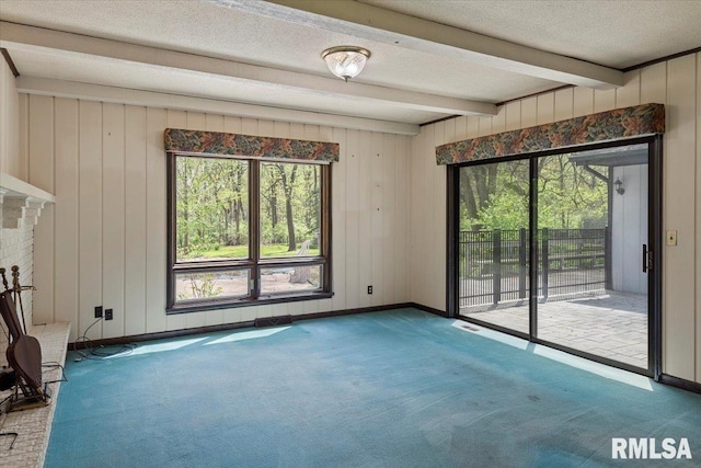454 Brian Ln, Dawson, IL 62520 - carpeted spare room with wooden walls, beam ceiling, a textured ceiling, baseboards, and visible vents