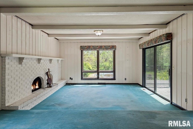 454 Brian Ln, Dawson, IL 62520 - unfurnished living room featuring carpet floors, wood walls, a wealth of natural light, and beamed ceiling