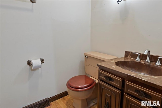454 Brian Ln, Dawson, IL 62520 - half bathroom featuring toilet, wood finished floors, and vanity