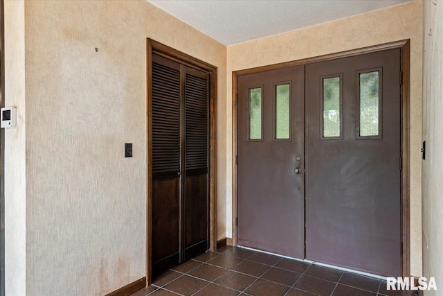 454 Brian Ln, Dawson, IL 62520 - foyer entrance with dark tile patterned flooring and baseboards