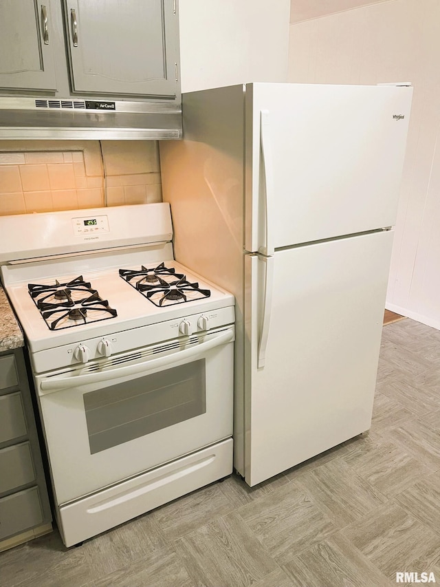 kitchen featuring white appliances, light countertops, gray cabinets, backsplash, and under cabinet range hood