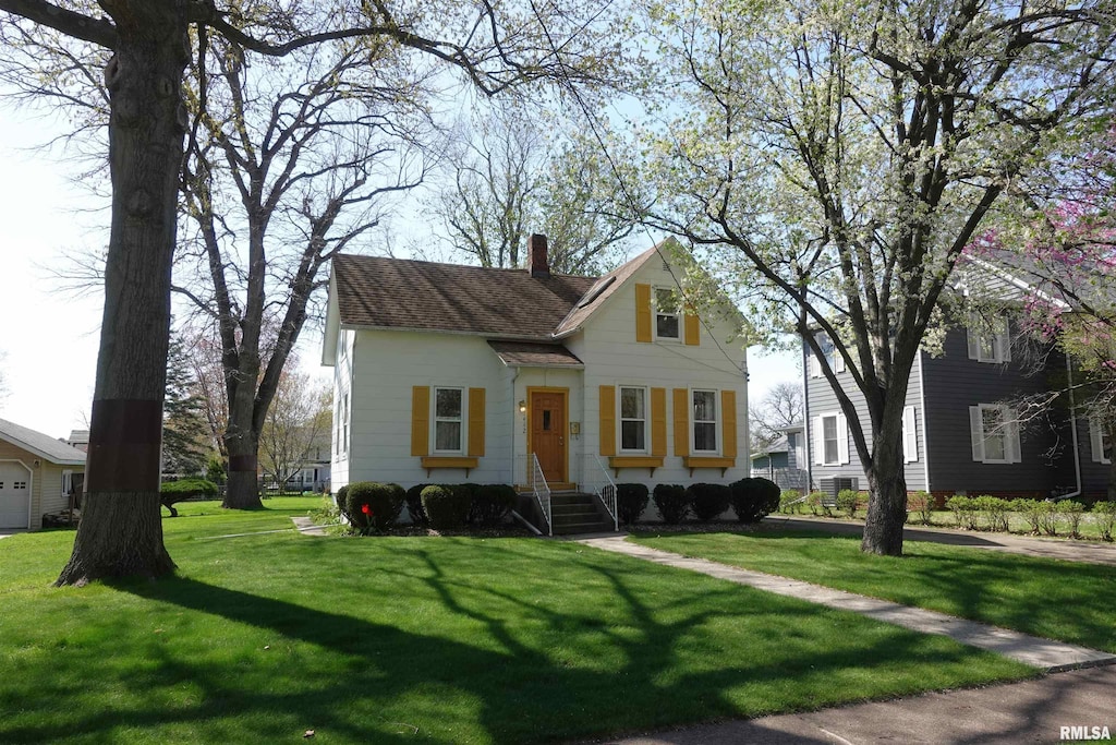 view of front of home featuring a chimney and a front yard