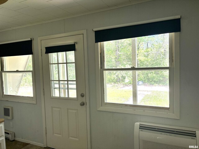 286 Kochs Ln, Meredosia, IL 62665 - doorway to outside with healthy amount of natural light, ornamental molding, a baseboard heating unit, and a wall unit AC