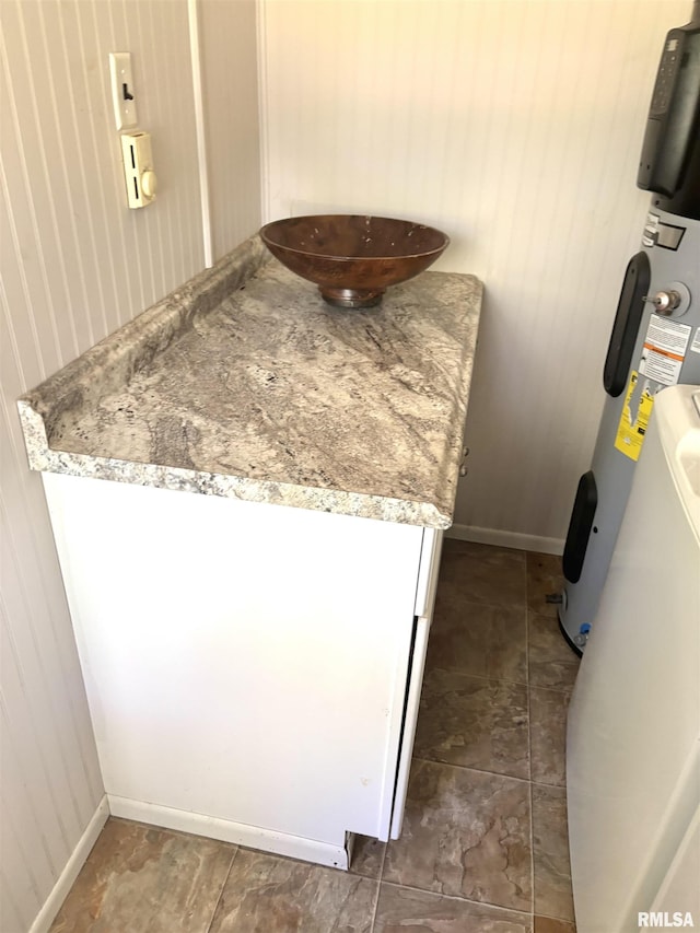 286 Kochs Ln, Meredosia, IL 62665 - detailed view of baseboards, wood walls, and water heater