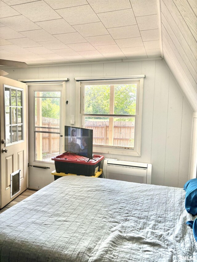 286 Kochs Ln, Meredosia, IL 62665 - bedroom with a wall mounted air conditioner, access to outside, and wood finished floors